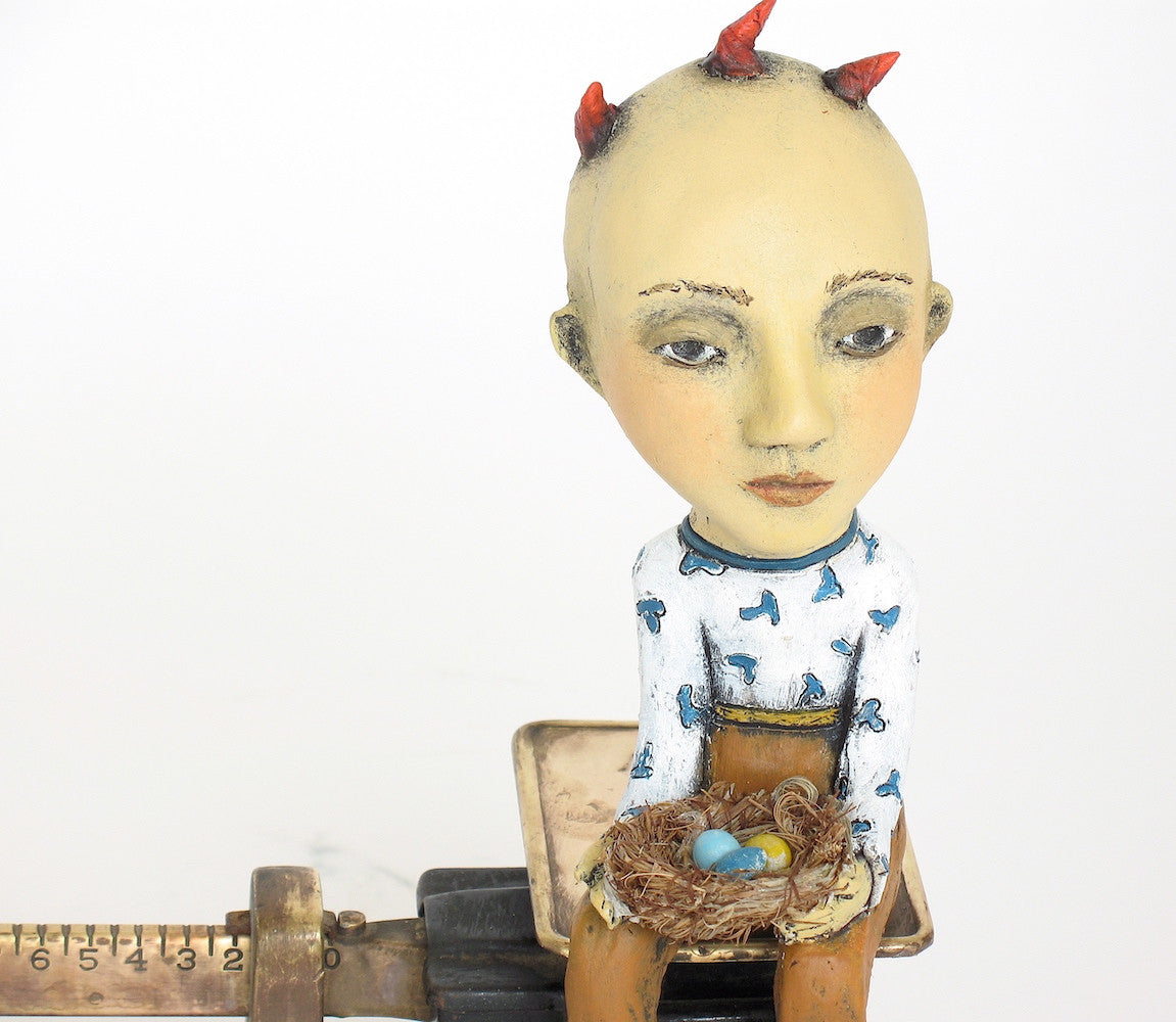SOLD   "The Weight of  Responsibility"  Original Ceramic Sculpture with Antique Scale by Jacquline Hurlbert