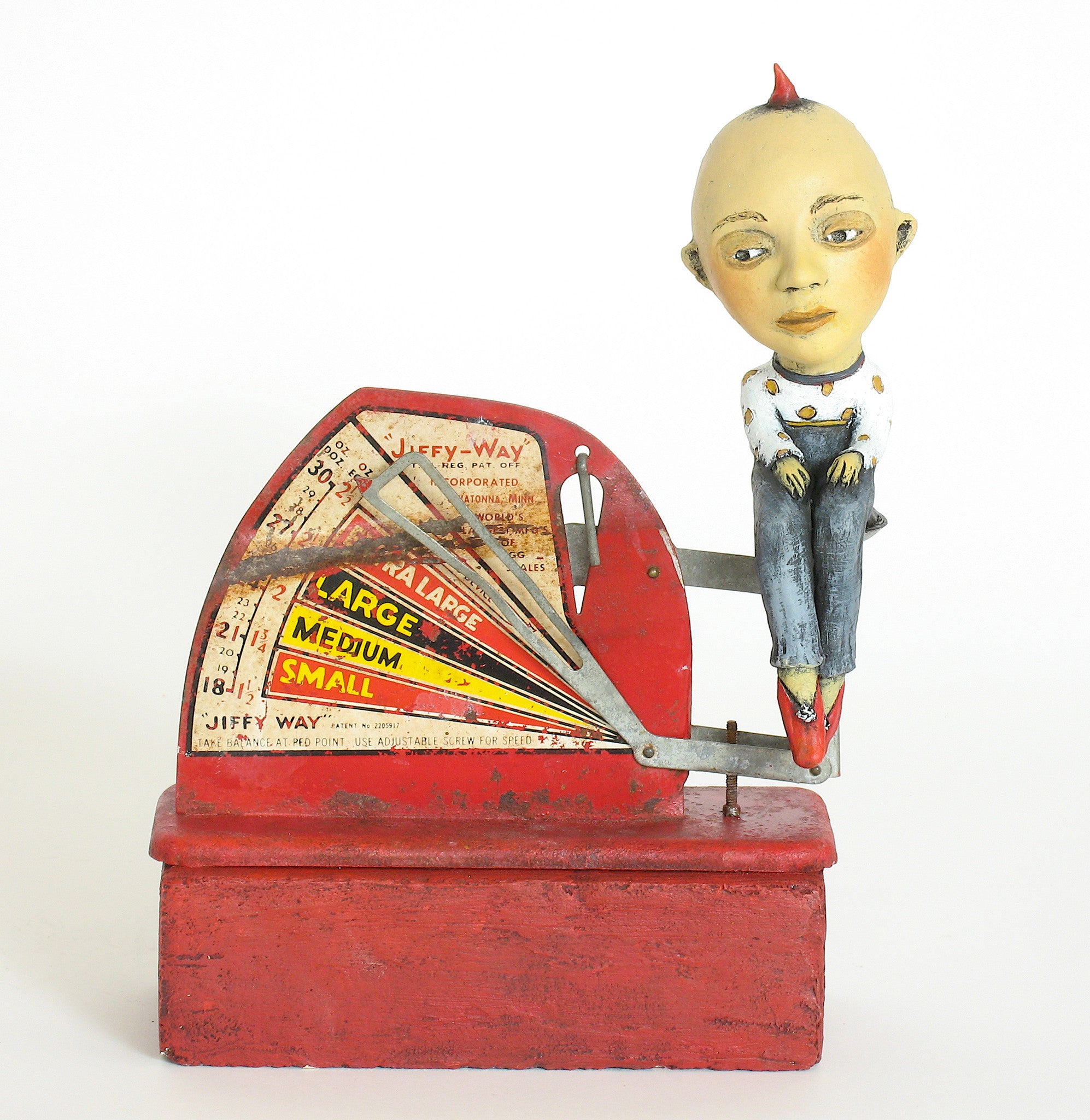 SOLD   "Egg-Headed Boy Weighs In"    original ceramic sculpture with antique egg scale by Jacquline Hurlbert